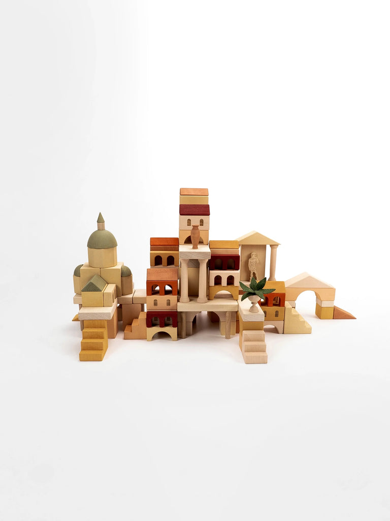 A Sabo Concept Italian Ancient City Blocks set assembled to resemble an Italian seaside town, featuring detailed buildings and a dome, on a white background.