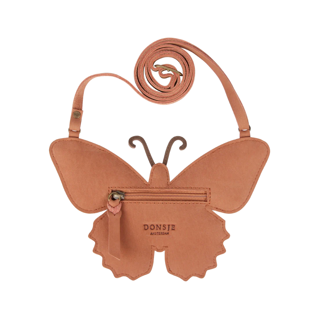 A unique Donsje Toto Papillon purse in cream metallic suede with an adjustable leather strap, featuring a central zipper and the brand "donste" embossed on the front.