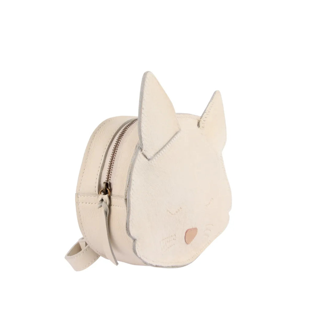 A small, circular white purse designed to resemble a Donsje Mini Leather Backpack - Cat, featuring pointy ears, closed eyes with eyelashes, and a pink heart-shaped nose. The bag has a zipper closure and adjustable straps.