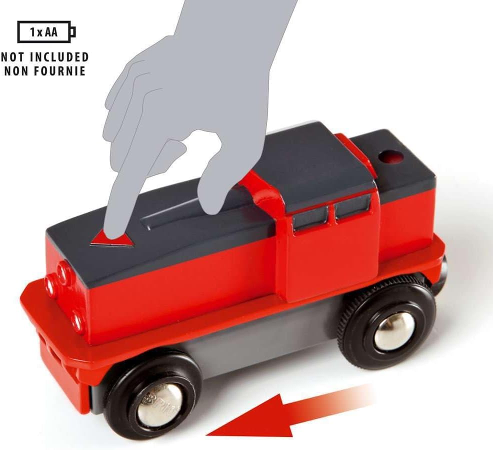 A hand presses a button on top of the BRIO World Train Set Cargo Harbour Set’s red and black engine; an arrow points forward, showing movement. Text notes it requires 1 AA battery (not included).