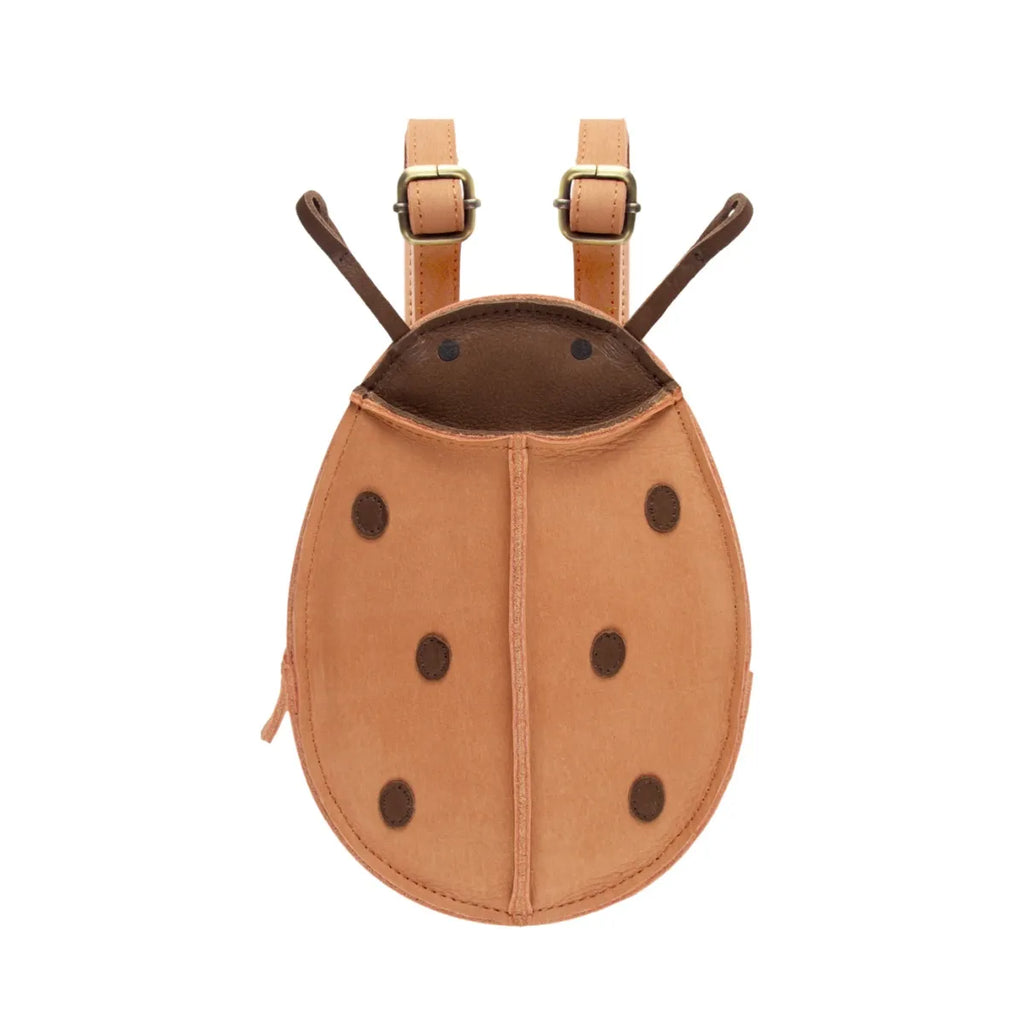 A cute, Donsje Mini Leather Backpack shaped like a ladybug made of 100% leather with brown details, featuring adjustable straps and a zipper along the side.