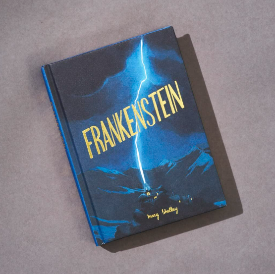 The "Frankenstein | Wordsworth Collector's Edition | Hardcover" rests on a gray surface. Its cover features a blue-tinged scene of lightning striking a house, with mountains hauntingly illuminated in the background.