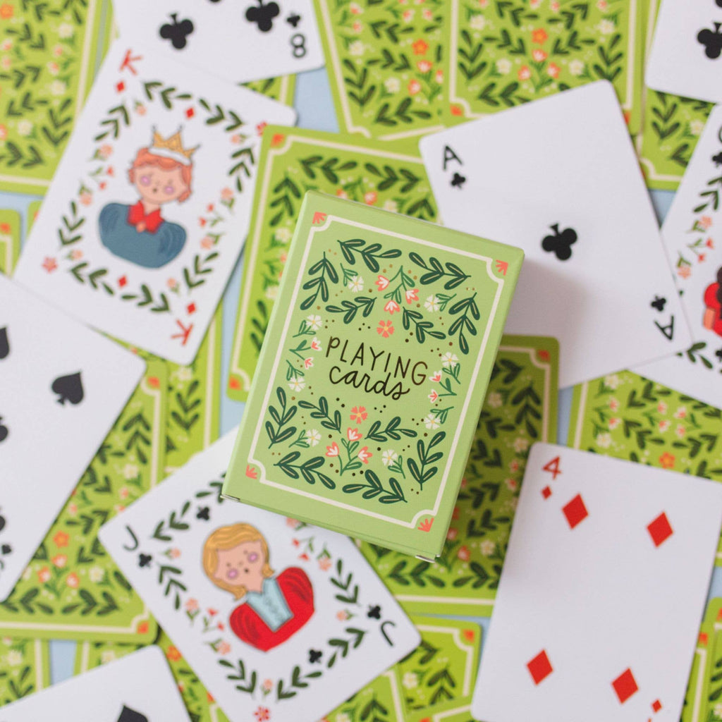 A green box labeled "Green Floral Deck of Playing Cards" is surrounded by its matching floral cards, including face cards and aces—ideal for an elegant game night. (Ships in approximately one week.).