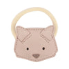 A children's Donsje Leather Hair Tie - Cat designed to look like a cat's face, featuring stitched details, black eyes, a small nose, and a circular handle at the top. This premium leather accessory adds an