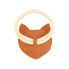 A whimsical children's accessory featuring a tan premium leather fox-shaped bib with the brand "Donsje" embossed on it, complemented by a cream-colored elastic band.