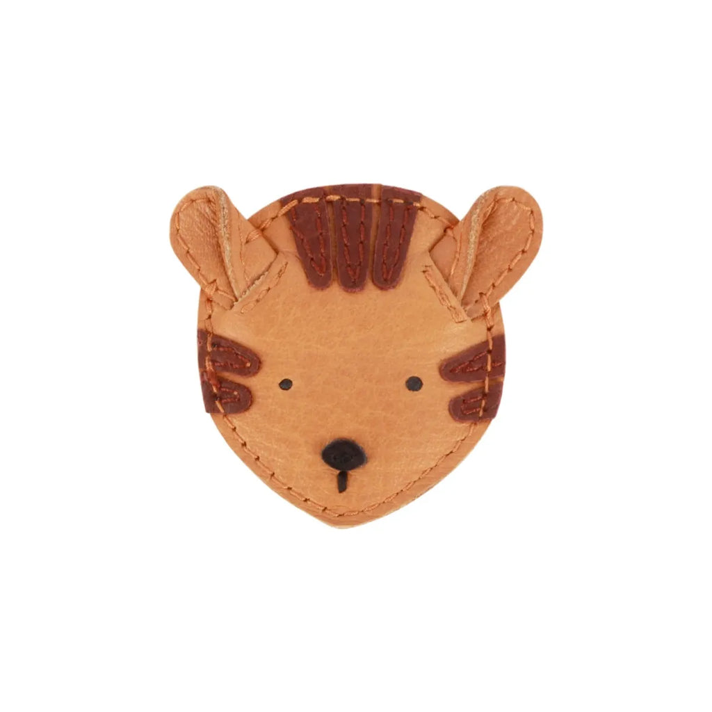 A simple, crafted Donsje Leather Hair Tie - Tiger with visible stitching and embossed details, isolated on a white background.
