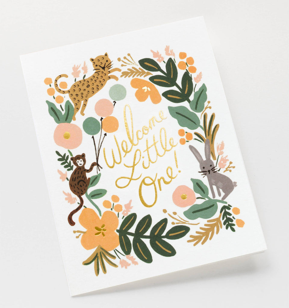 The Menagerie Baby Card features floral illustrations and a cheetah, monkey, and rabbit around metallic gold foil text "Welcome Little One!" on a white background. The card is blank inside for your personal message.
