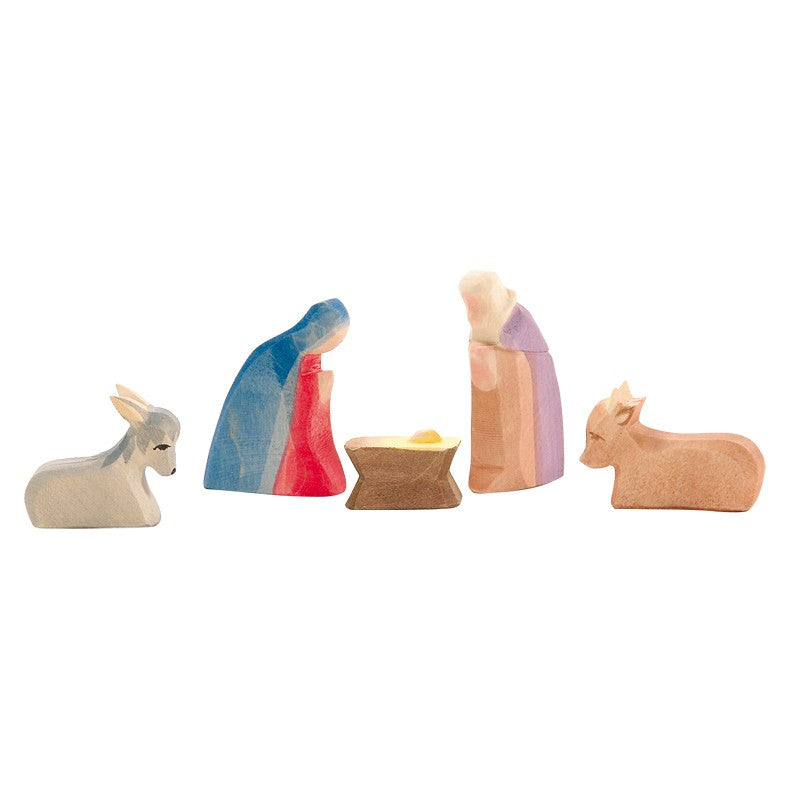 The Ostheimer The Holy Family Mini Set - 5 Pieces (Small) features pastel-painted wooden figures: donkey, Mary in blue/red, Joseph in purple/beige, baby Jesus in a manger, and an ox—a charming addition for Waldorf toy collectors.