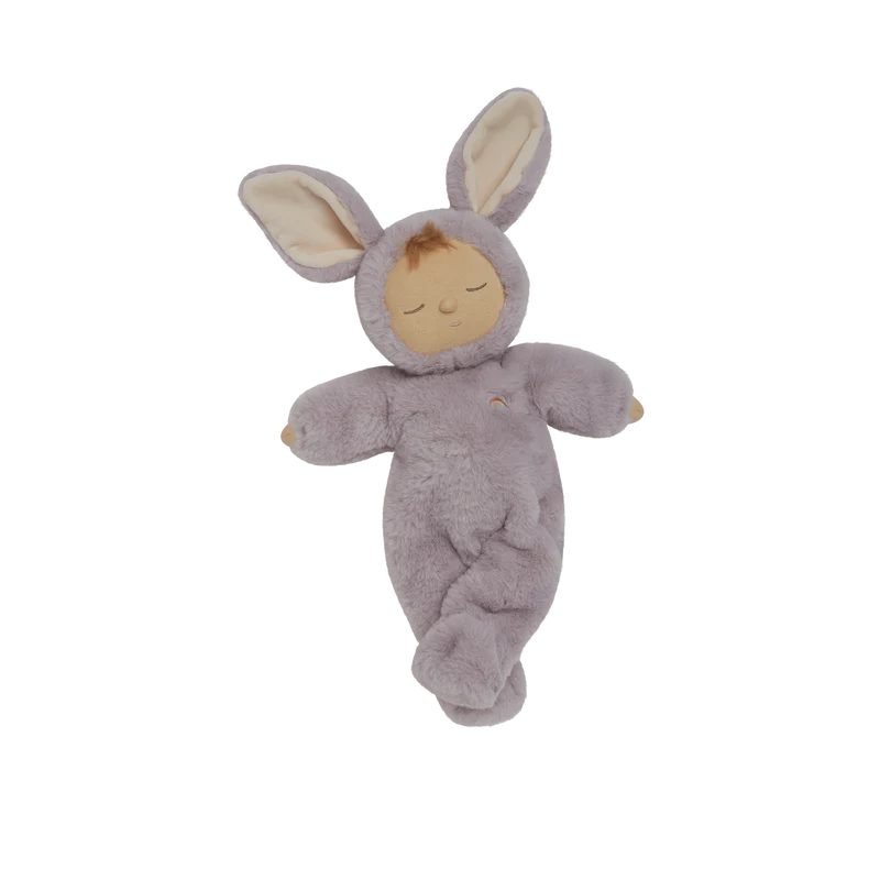The Olli Ella Cozy Dinkum - Bunny Twinkle is a posable plush doll in a soft, light purple bunny suit with long ears and a sleepy face, shown lying on a plain white background. Perfect for cuddles or display.