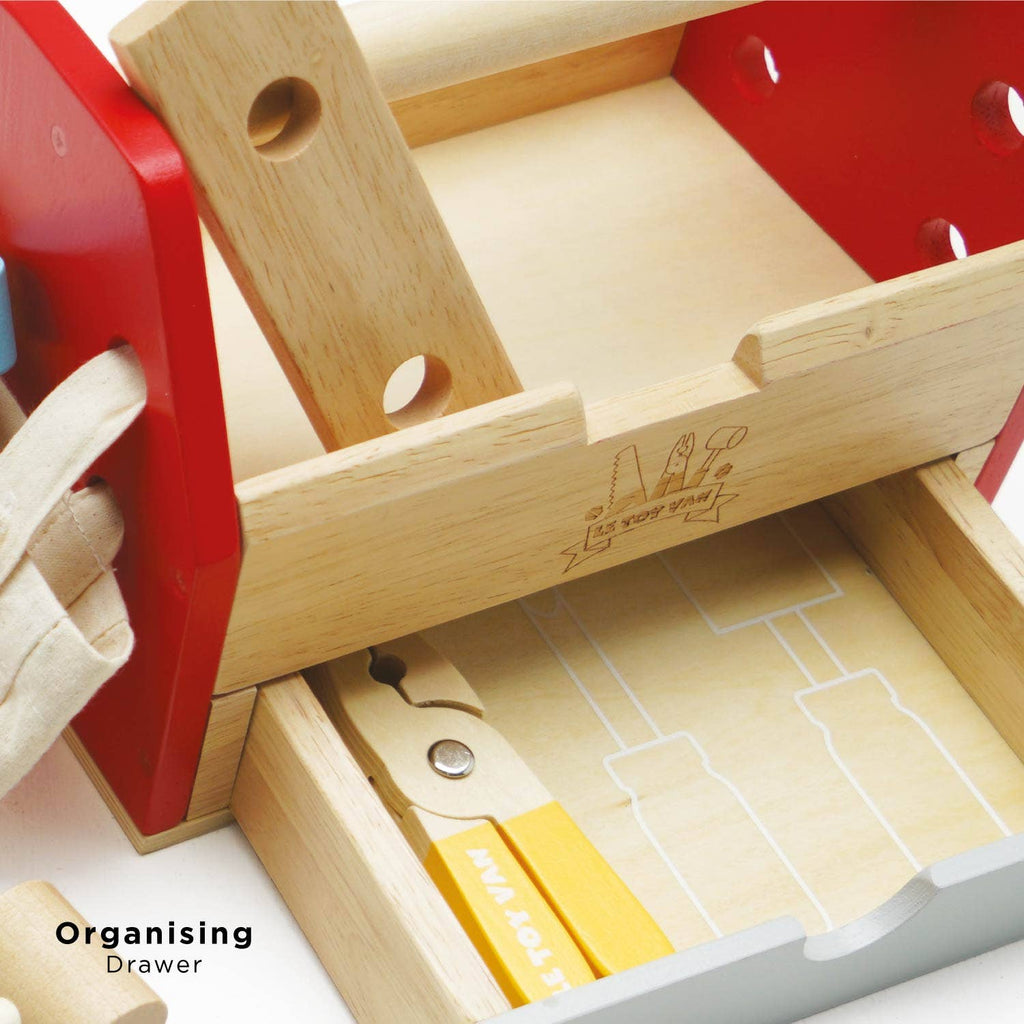 A close-up of the Tool Box & Wooden Tools set featuring a slide-out drawer with tool outlines for organizing, plus a toy screwdriver and pliers. The toolbox sides are red and "Organising Drawer" is printed on it. Perfect for early years play.