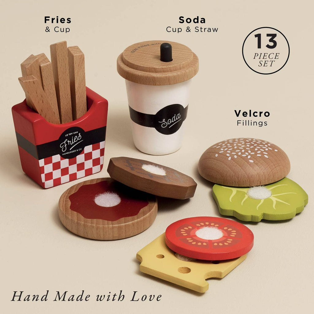 The Gourmet Hamburger Set (ships in one week) includes wooden toy fries in a red box, a soda cup with straw, and Velcro burger ingredients—ideal for play kitchens. Features are labeled; packaging reads "Hand Made with Love.
