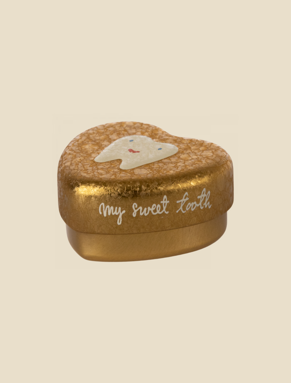 A small, heart-shaped golden box with a textured surface. The lid features a smiling tooth illustration and the words "my sweet tooth" written in cursive, making it the perfect Maileg Tooth Box for preserving childhood memories.
