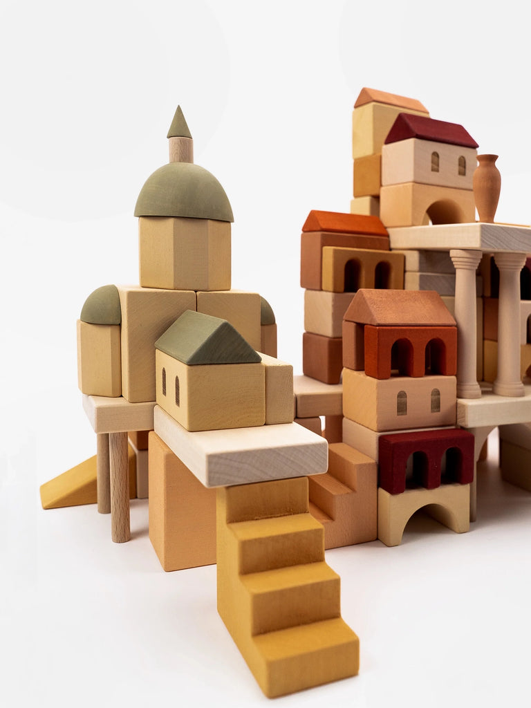A detailed Sabo Concept Italian Ancient City Blocks set arranged to resemble a miniature village with a variety of buildings, including some with domed and multi-tiered structures, on a white background.