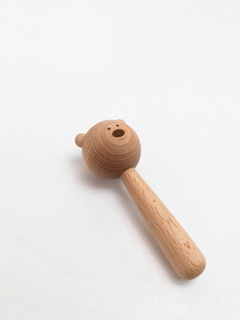The Sabo Concept Bear Rattle - Natural, made from natural materials with a carved bear face and smooth handle, is shown on a white background.