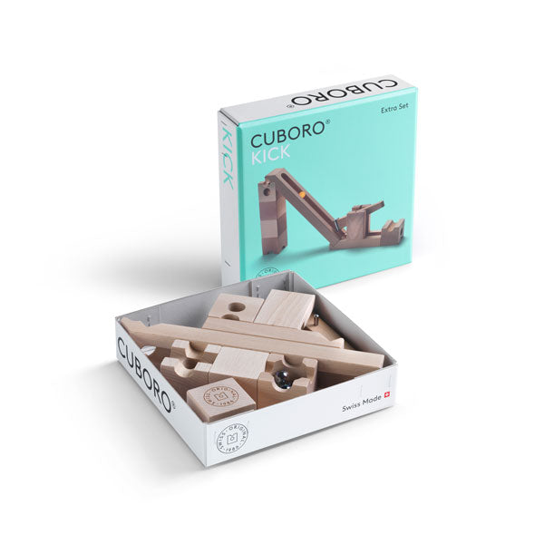 A Cuboro Kick Marble Run Extra Set featuring wooden blocks partially unpacked from an open box, with the product's packaging visible in the background.