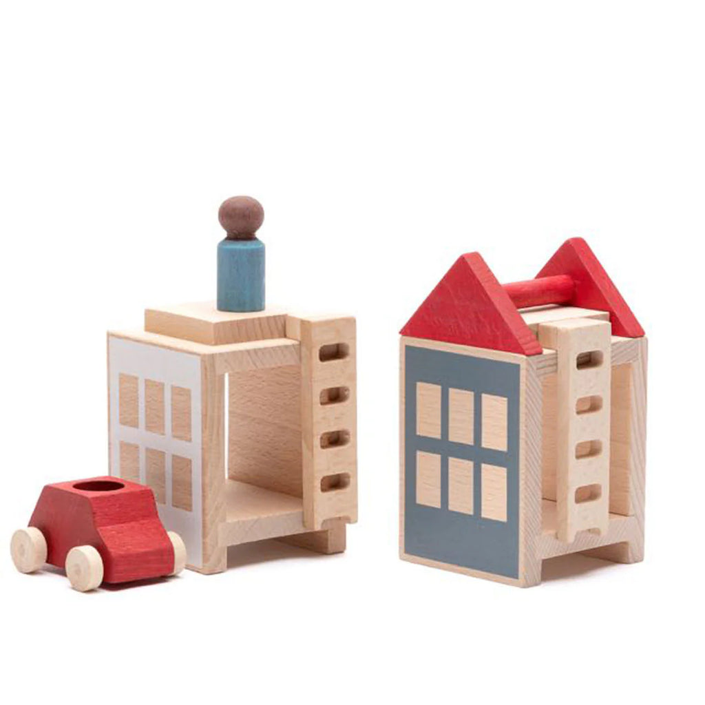 The Lubulona Lubu Town Summerville Set includes two wooden buildings with painted windows and roofs, a small red car, and a blue-brown figure. These eco-friendly toys are displayed on a white background.