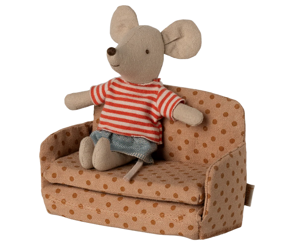 A small stuffed toy mouse in a red and white striped shirt and blue shorts sits on the PRE-ORDER: Sofa Bed, Mouse - Dots from SuitCasa, covered in brown polka-dotted fabric (Estimated Ship Date: Late September).