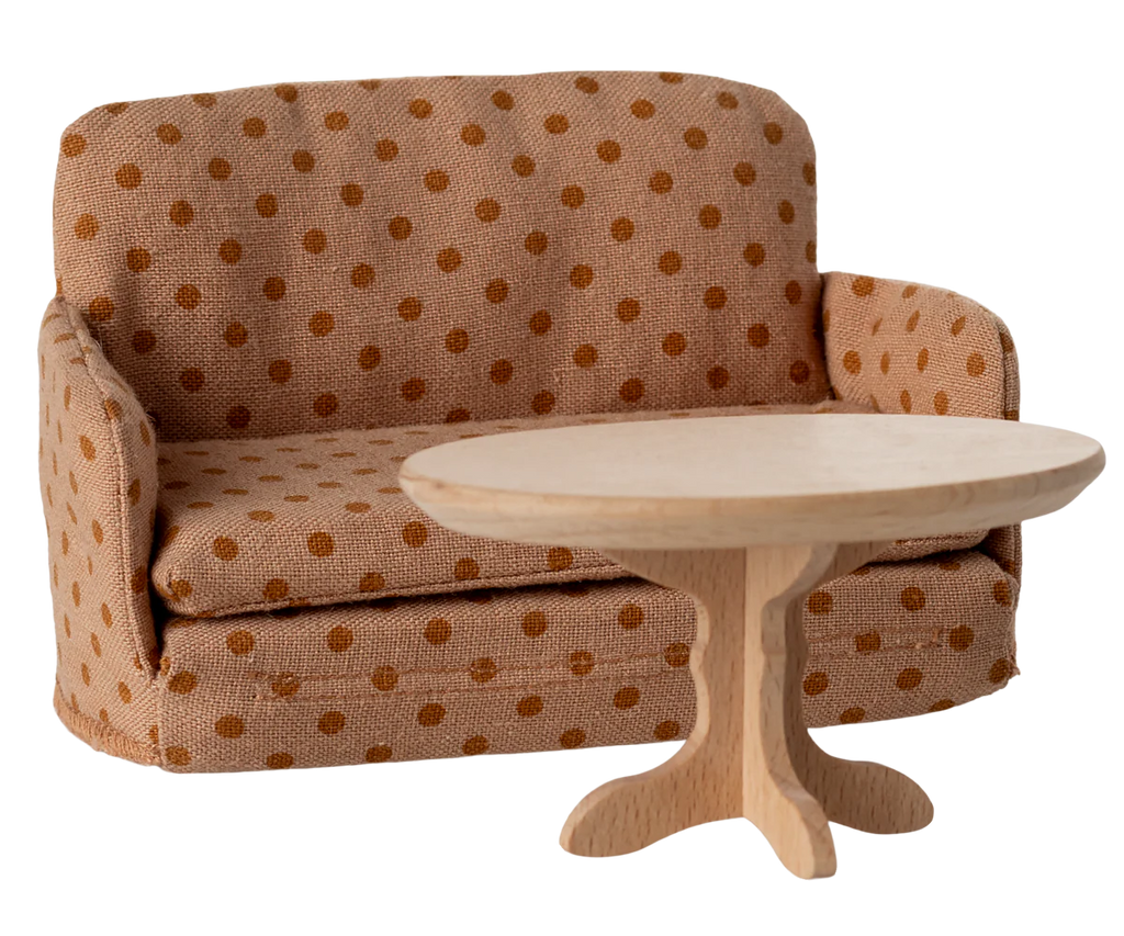 The PRE-ORDER: Sofa Bed, Mouse - Dots (Estimated Ship Date: Late September) features a tan and brown polka dot pattern, making it a charming SuitCasa living room accent or cozy sofa behind a round, light wooden pedestal table.