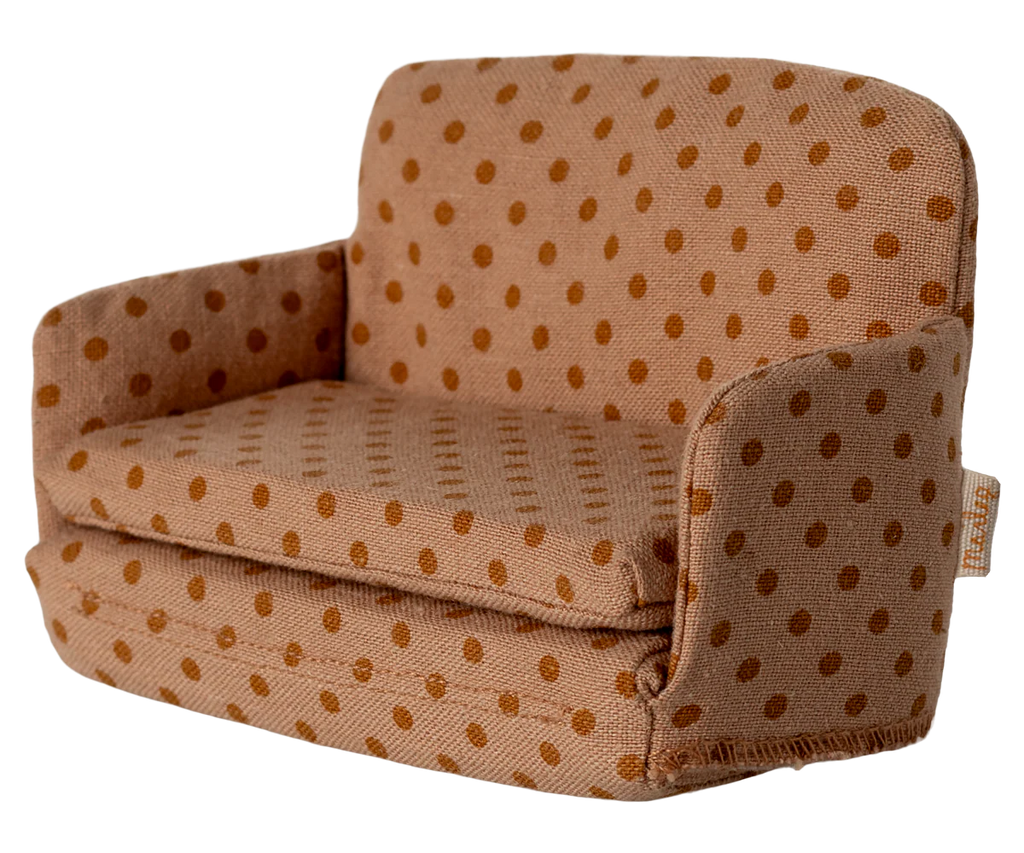 The PRE-ORDER: Sofa Bed, Mouse - Dots (ships late September) features tan upholstery with orange polka dots and padded arms and backrest—perfect for a cozy SuitCasa living room. Shown angled.