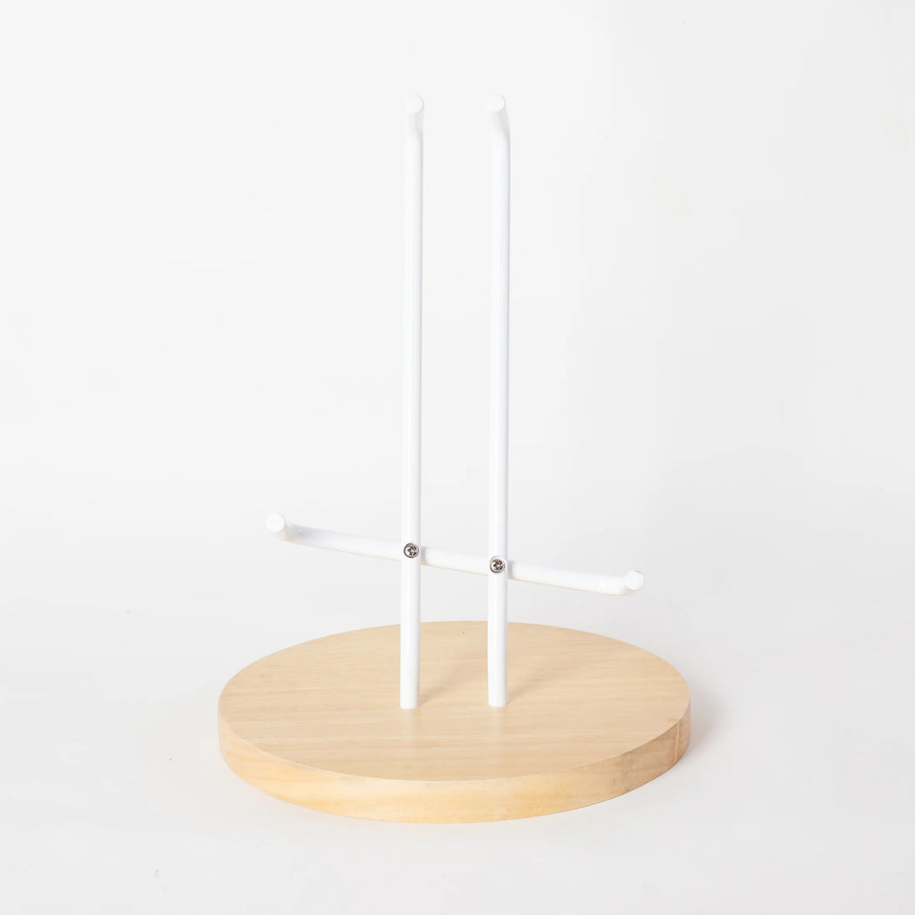A guitar stand with a circular wooden base.