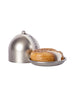A freshly baked pie with a golden crust is served on a small, circular metal dish, partially covered by a shiny metallic cloche with a handle from the Maileg Farmhouse - Fully Furnished collection, against a plain white background.