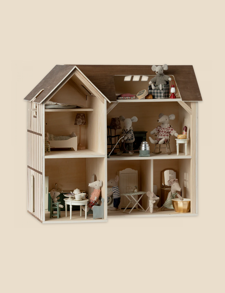 A detailed Maileg Farmhouse Dollhouse resembling a realistic home, featuring rooms with small furniture, decor, and stuffed mice in various poses, mimicking daily life activities.