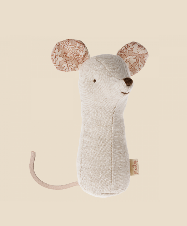 A soft toy shaped like a mouse, made of light beige fabric. It features large ears with floral-patterned fabric and a small tail made of the same light beige material. The toy has embroidered eyes, nose, and a gentle smile. Part of the Lullaby Friends collection, it includes a baby rattle inside: Maileg Lullaby Friend Rattles, Mouse - Nature.
