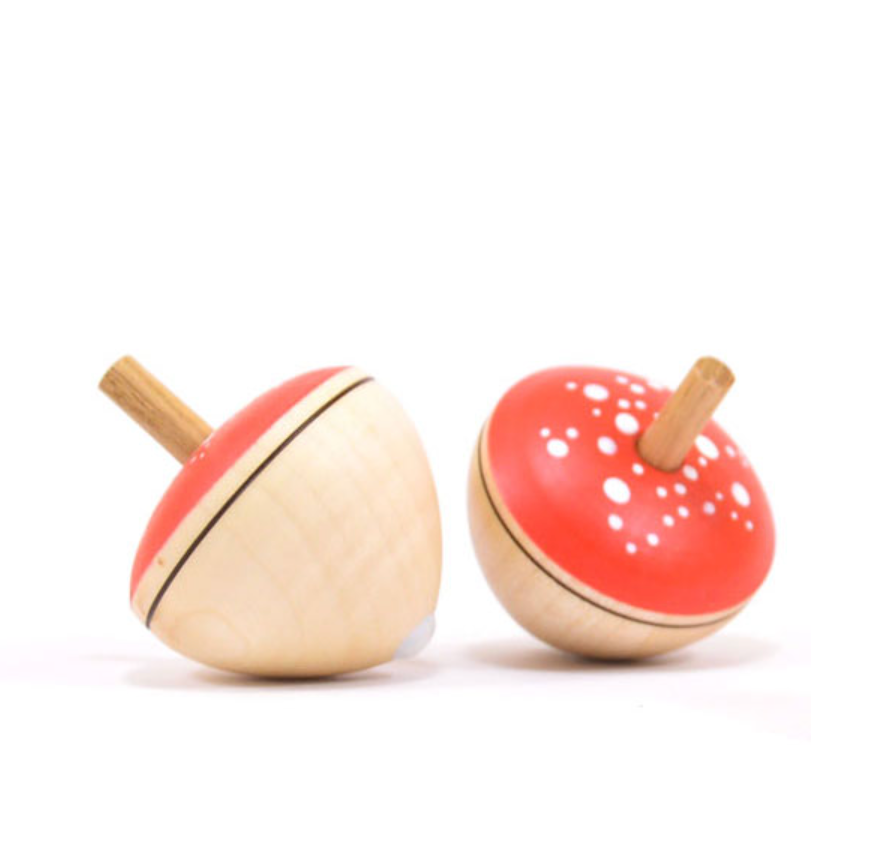 A set of two Egg-Shaped Spinning Tops with red, mushroom-style tops featuring white spots and natural wood bases. These toys are safe for worry-free play and meet toy safety standards.