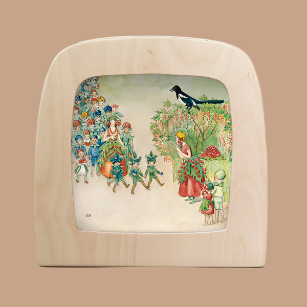 Set in a rounded wooden frame, the Silhouette Only - Around The Year (August) for Toverlux Lamp features a vintage garden scene with people in floral costumes, blooming trees, and children observing a bird perched on a branch.