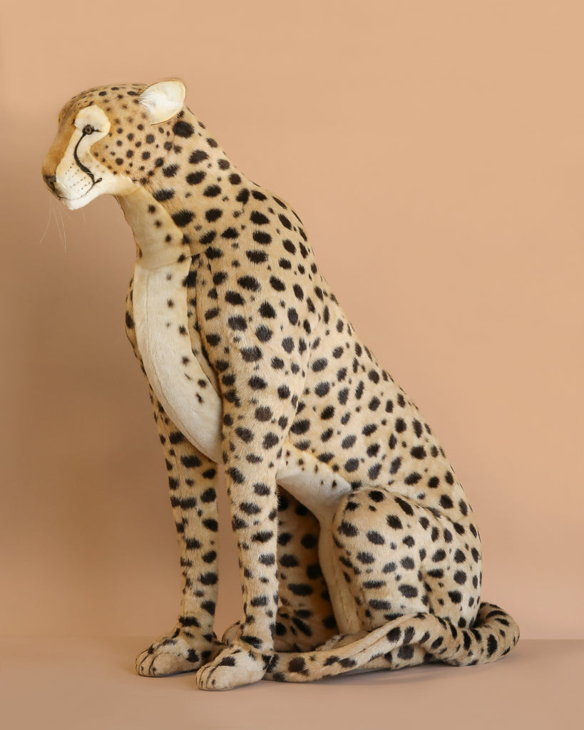 The Life-Size Cheetah Stuffed Animal, 44"—a handcrafted plush with lifelike black spots—sits upright against a beige backdrop. Final Sale.