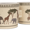 Two beige Konges Sløjd Wooden Bongo Drums - Safari with an African savannah motif featuring giraffes, elephants, and trees. One container is made from FSC-certified beech wood and has a label stating "100%".