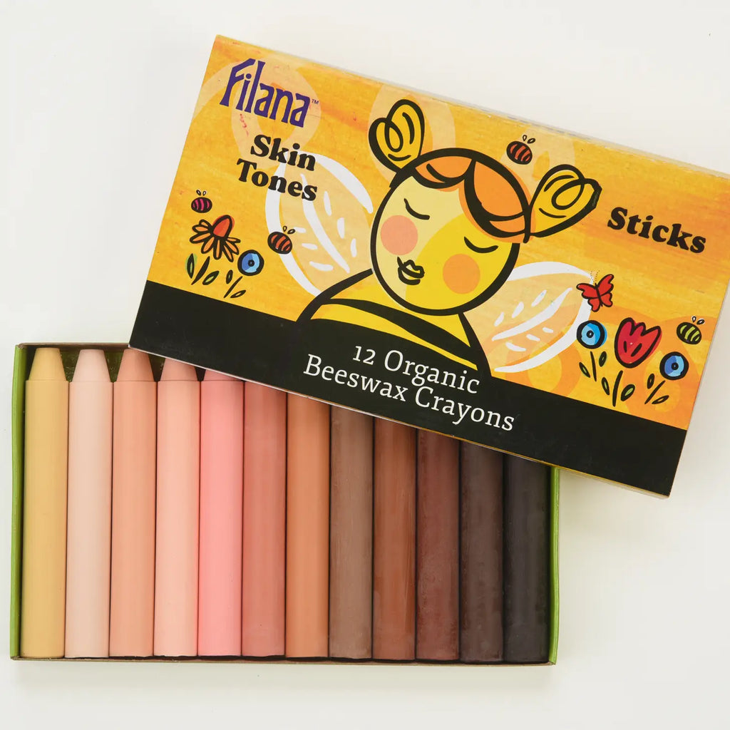 A box of Organic Beeswax Crayons: 12 Skin Tones in Sticks featuring a colorful design and 12 different skin tone shades, arranged neatly from light to dark.