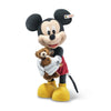 Steiff Collectible Mickey Mouse with Teddy Bear, 12 Inches, dressed in traditional red shorts and yellow shoes, hugging a small brown teddy bear. The toy stands against a white background.