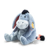 A Steiff, Disney's Winnie the Pooh Eeyore Plush Stuffed Toy, 10 Inches, sitting with a slight slouch, has a soft blue and pink color scheme, and features a friendly, som