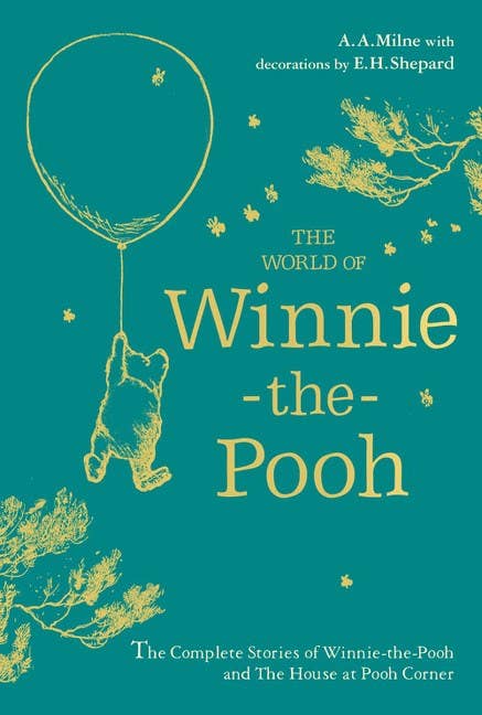 Book cover for The World of Winnie-the-Pooh shows Winnie-the-Pooh holding a balloon, surrounded by trees and stars on a teal background, capturing the charm of this beloved children's story.