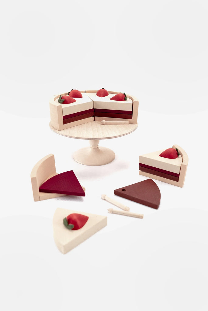 Wooden playset featuring a Handmade Chocolate Layer Cake On A Stand, sliced into six pieces, surrounded by a knife and fork on a plain white background.