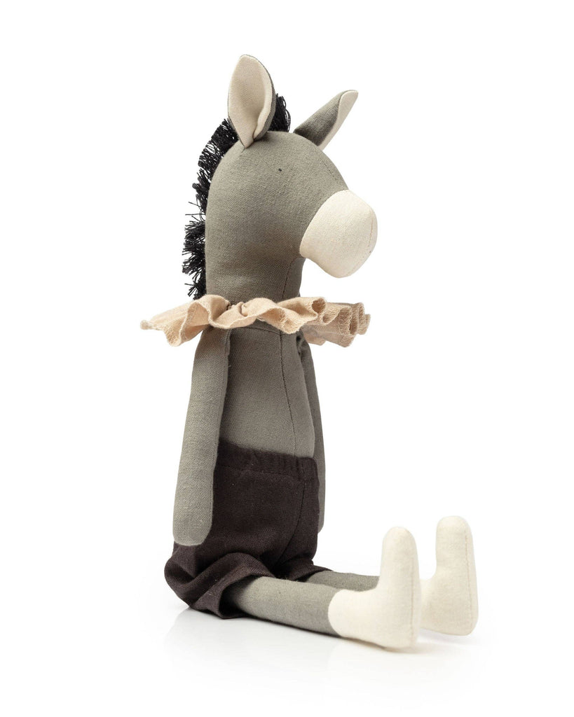 Meet Darwin the Donkey, a cuddly plush toy made from recycled polyester. It features a grey body, black mane, beige snout and feet, and sits relaxed against a white backdrop with its frilly collar adding charm as its legs stretch forward.