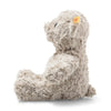 A fluffy gray Steiff Honey Teddy Bear, 11 Inches sits facing left with the distinctive Button in Ear and a visible yellow tag, against a white background.