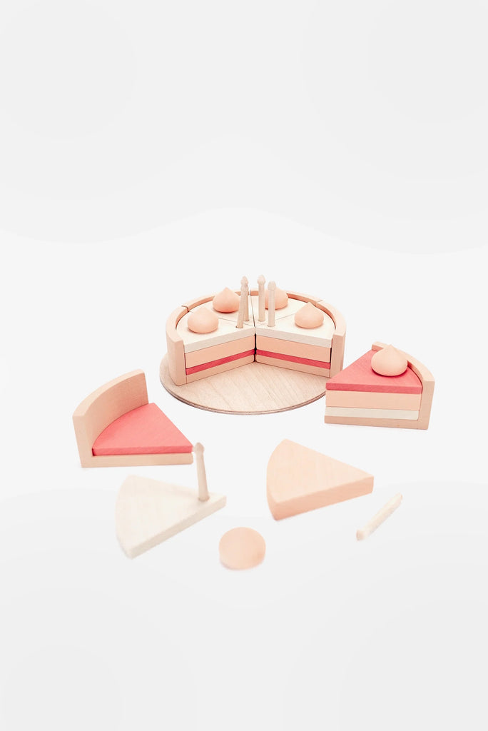 A Handmade Strawberry Layer Cake On A Stand set on a white background, including slices of cake, decorative toppings, and a serving spatula, arranged neatly with some pieces detached. The set is coated with non-toxic paint.