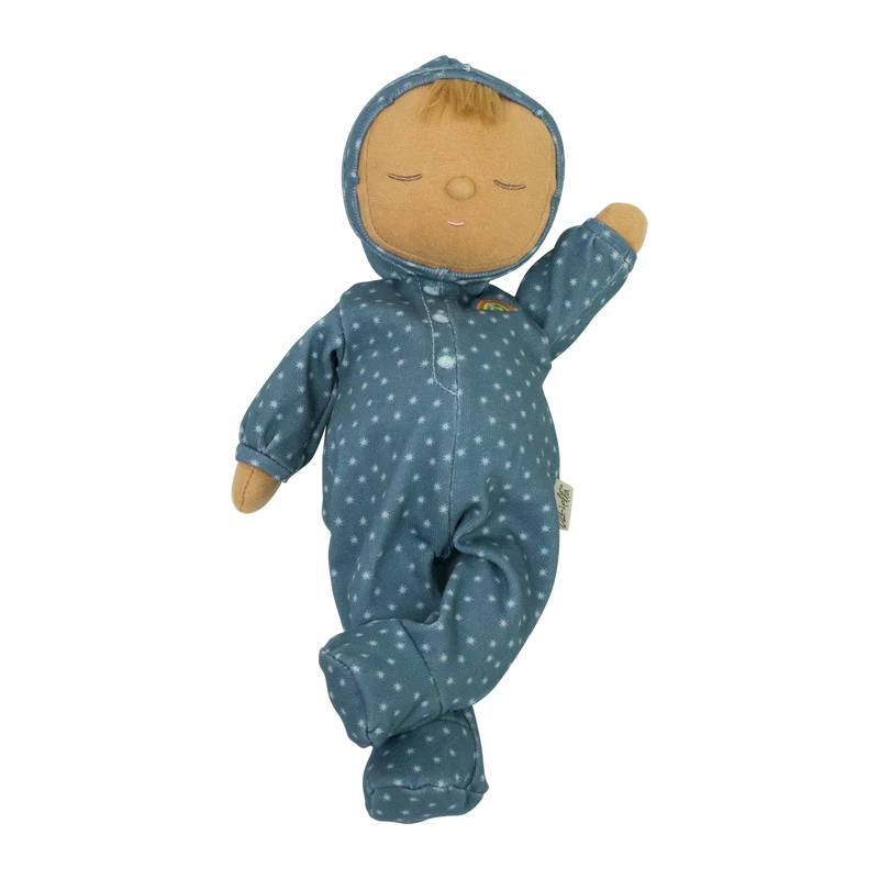 A Olli Ella Dozy Dinkums - Bug doll with a sleeping face wearing a blue onesie with white polka dots against a black background. The doll has a flat, round head resembling a moon, adding a