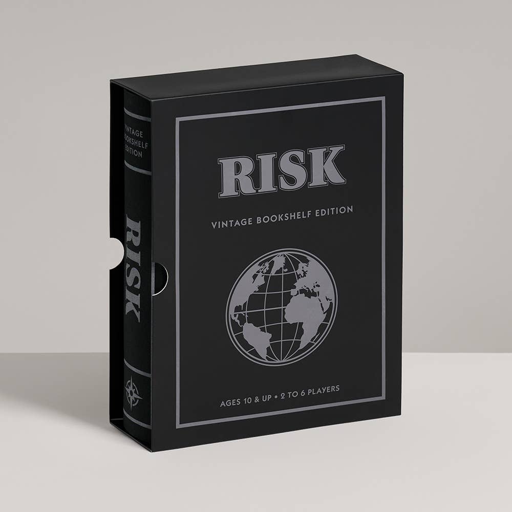 The Board Game: Risk Vintage Bookshelf Edition, in a black box with a globe design and silver text, stands upright on a light surface—ideal for fans of classic 1996 board games.