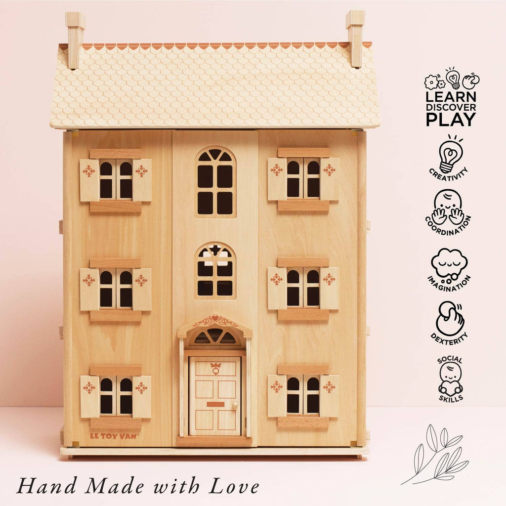 The Grand Natural Wood Doll House features four windows, a door, and floral accents. Hand-made from sustainable wood to inspire imaginative play and develop creativity, coordination, dexterity, imagination, and social skills.