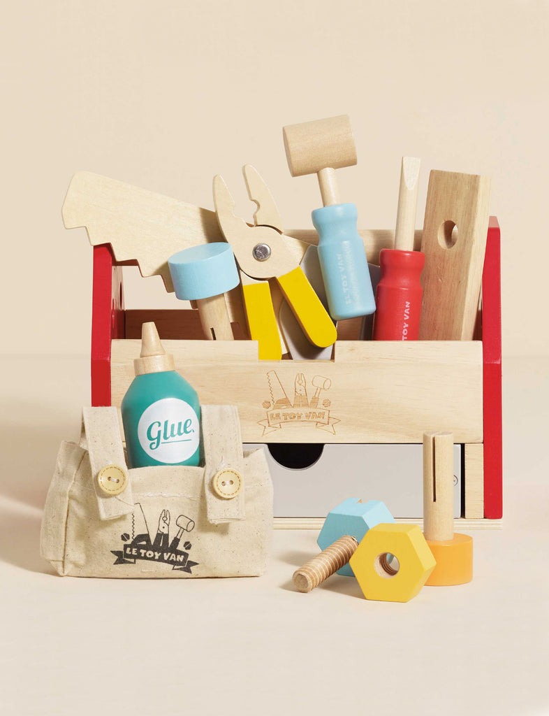 The Tool Box & Wooden Tools set includes colorful toy tools like a saw, pliers, screwdrivers, a wooden glue bottle, bolts, and a handy front fabric tool bag—ideal for developing fine motor skills in early years play.