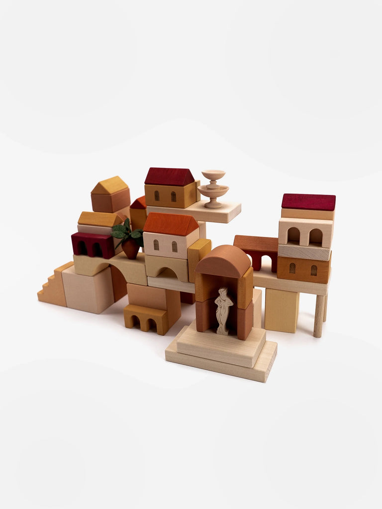 A collection of Sabo Concept Italian Courtyard Blocks shaped like various buildings and architectural elements, arranged together on a white background.