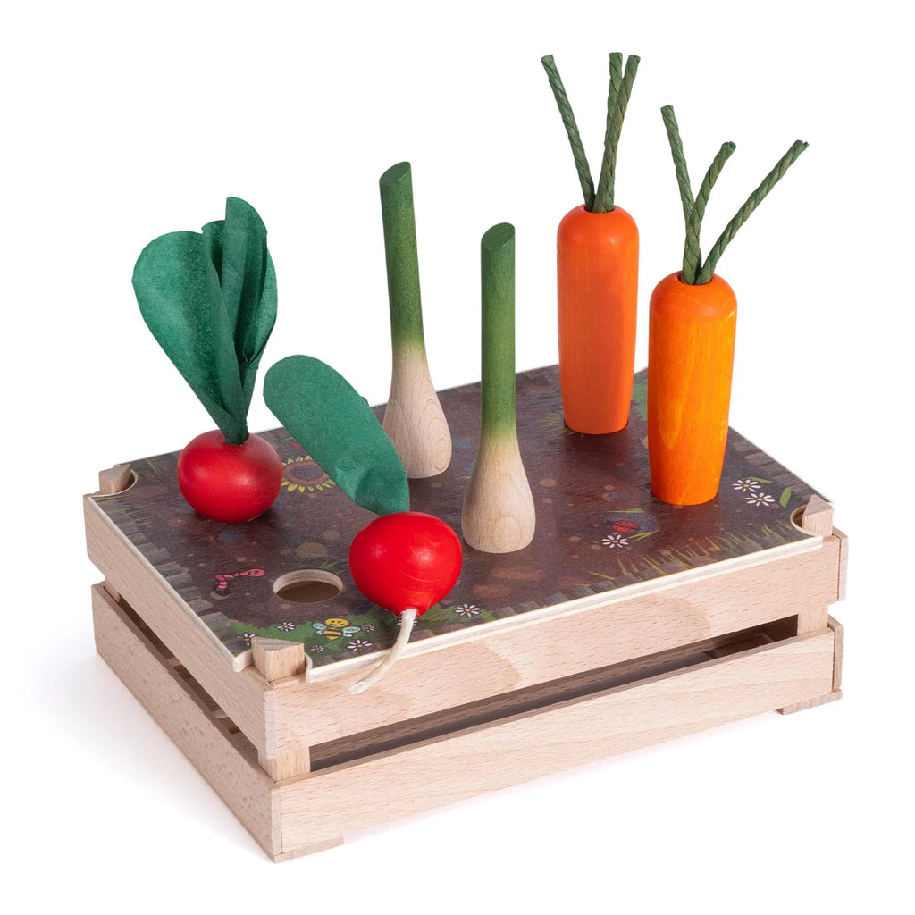 The Erzi Vegetable Patch Garden Set features toy veggies—two red radishes, two green-topped leeks, and three orange carrots with leafy stems—all standing upright like a mini garden.