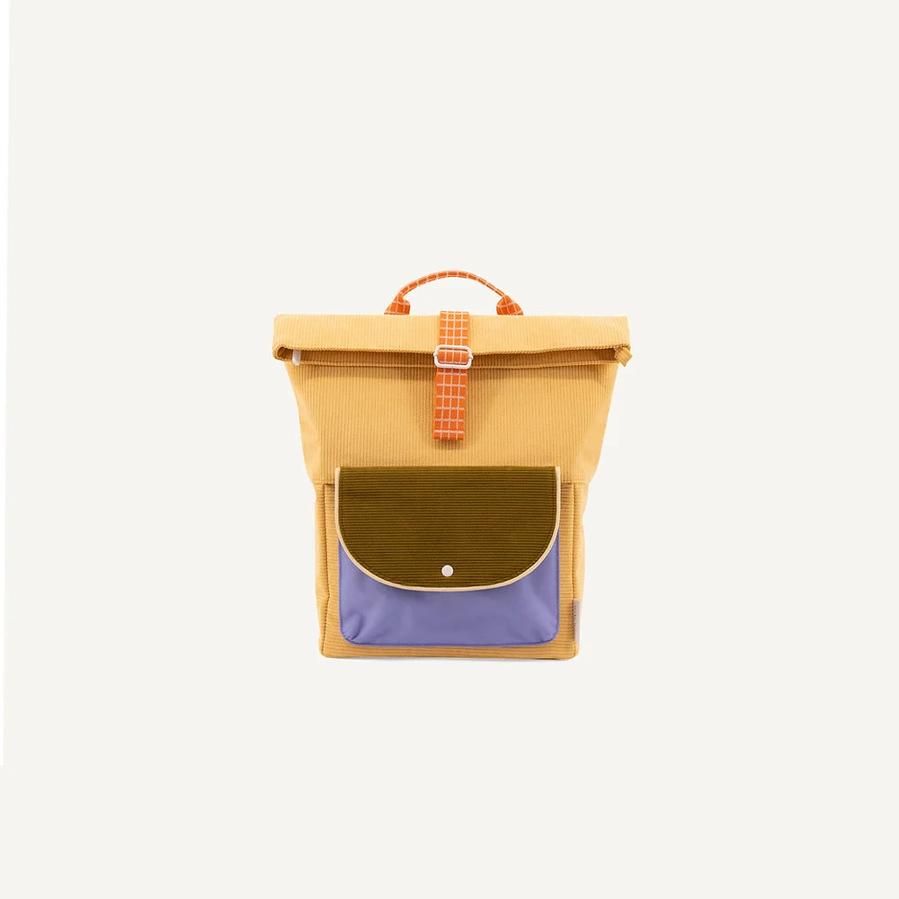 A stylish Sticky Lemon corduroy backpack featuring a yellow main compartment, a blue bottom pocket with a green flap, and an orange checkered handle, isolated against a white background.