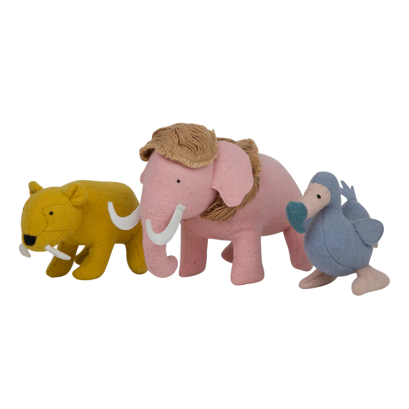 Three Olli Ella Holdie Extinct Animals, including a saber tooth tiger, a mammoth with visible tusks and hair, and a small blue bird, lined up against a white background.