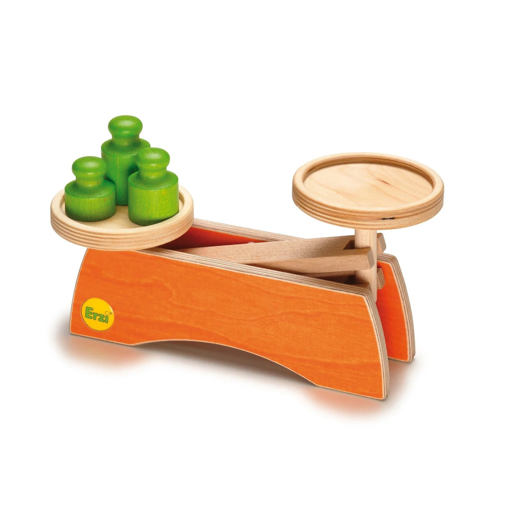 The Erzi Grocer's Scale For Pretend Food is a wooden balance scale with an orange base, four green weights, and a circular platform—ideal as a children’s learning toy or play shop accessory.