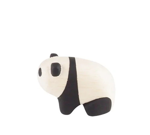 The Handmade Tiny Wooden Panda Child is a small, minimalist figurine crafted from Albizia wood by Bali artisans, showing a white body with black legs, ears, and eye patches on a plain white background.