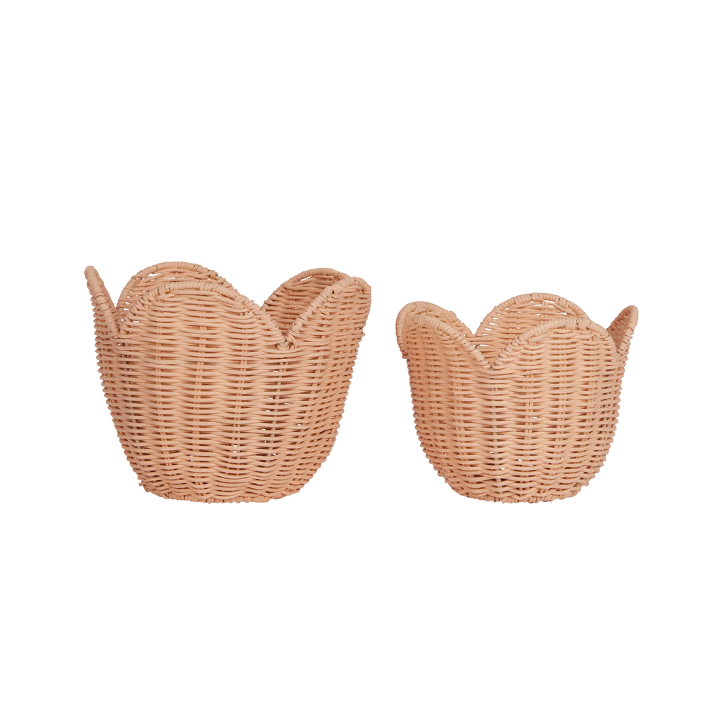 Two Olli Ella Rattan Lily Baskets designed to look like swans, facing opposite directions, displayed against a black background with horizontal white stripes.